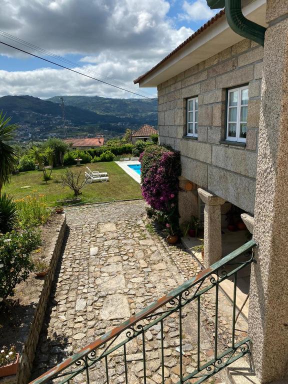a house with a stone walkway next to a house at Casa Ana Rosa in Arcos de Valdevez