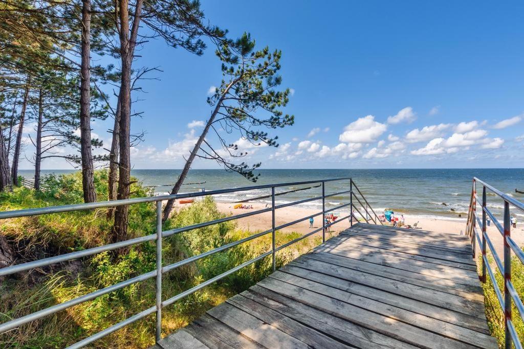 a boardwalk leading down to the beach at Apartament4siostry65 in Ustronie Morskie