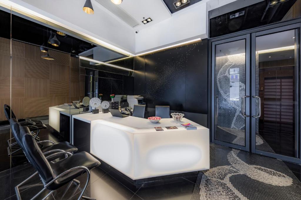 a salon with a white counter and black chairs at The Mercer in Hong Kong
