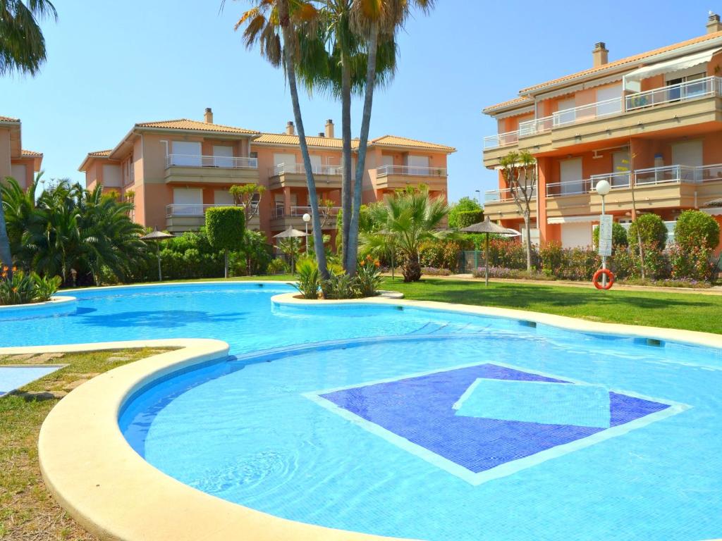 a large swimming pool in front of a building at Apartamento La Senia in Jávea