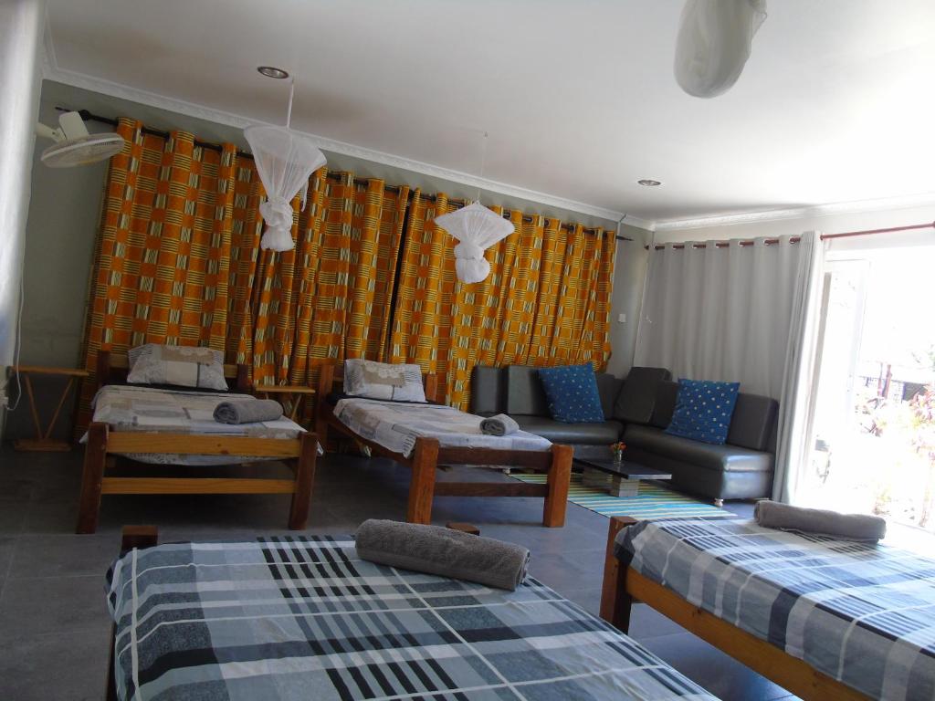 Postel nebo postele na pokoji v ubytování IDC Guest House