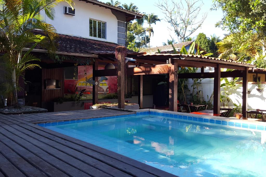 a swimming pool in front of a house at Che Lagarto Paraty in Paraty