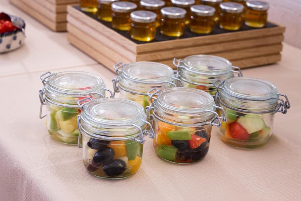 a group of jars filled with fruit on a table at Hotel Perrin - former Carlton in Luxembourg