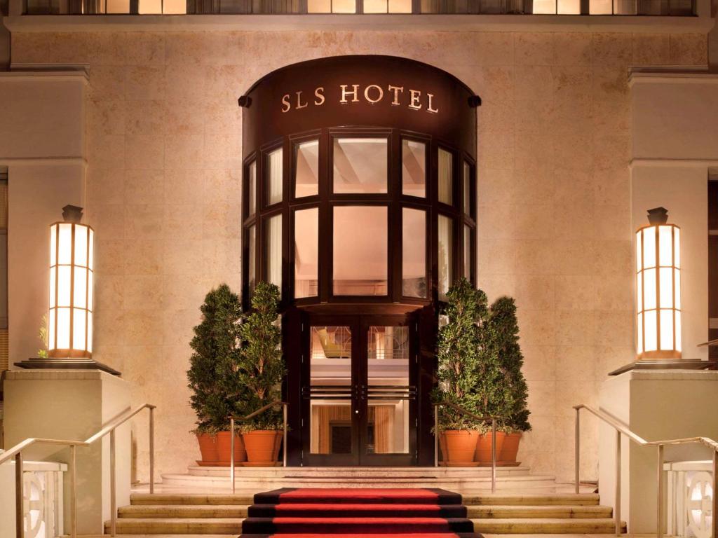 a building with a siss hotel entrance with a red carpet at SLS South Beach in Miami Beach