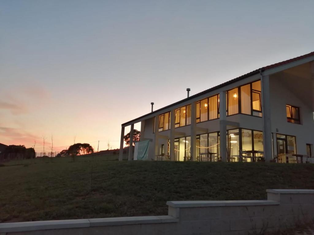 a building with a sunset in the background at Langre Wayve House in Langre