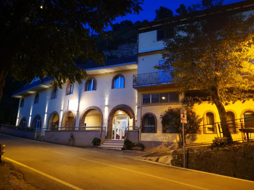 a large white building at night at Hotel Ristorante Farese in Melfi