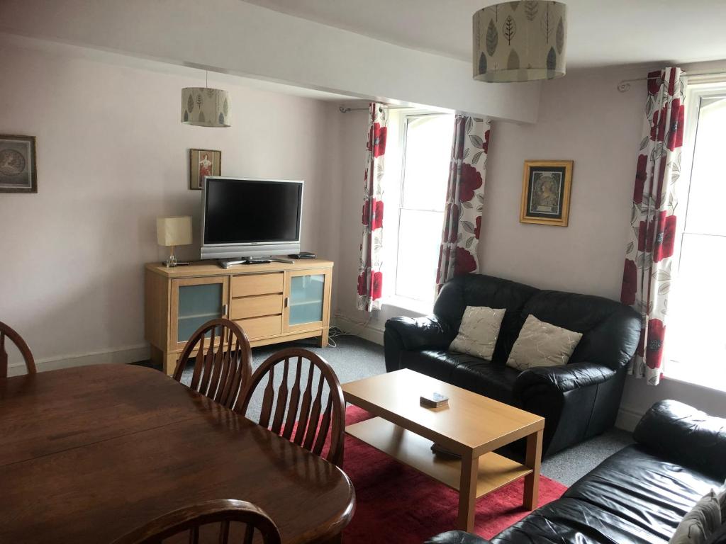 a living room with a couch and a table at 4c Belmont Terrace in Buxton