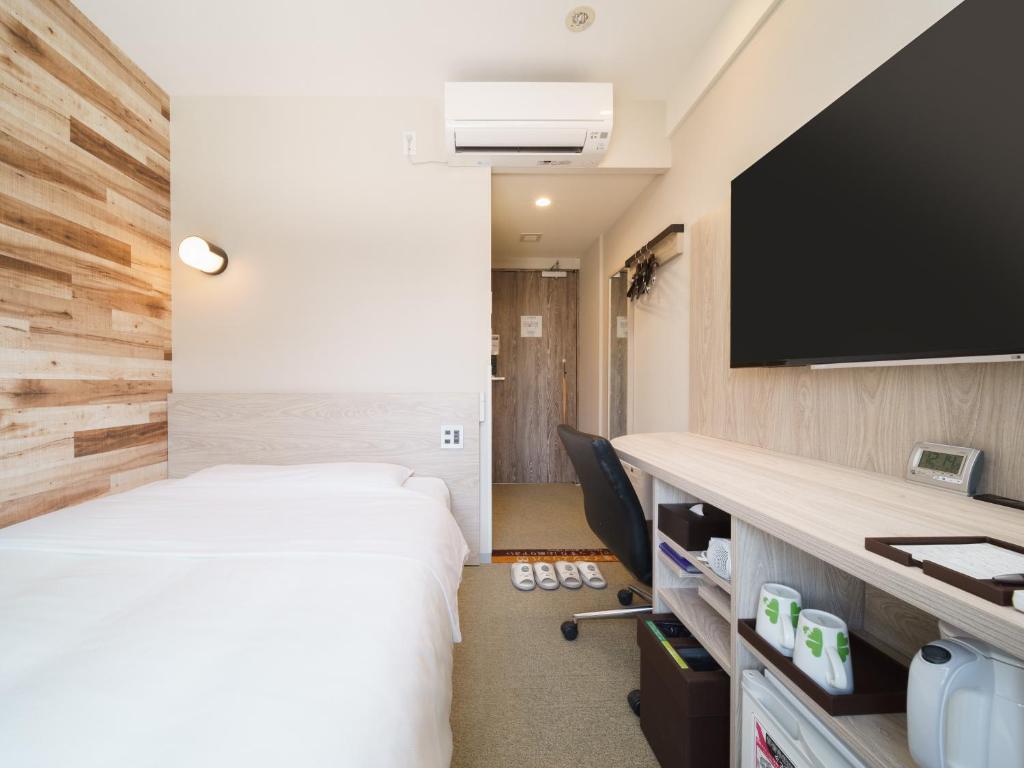 Postel nebo postele na pokoji v ubytování Super Hotel Shinagawa Aomono-Yokocho
