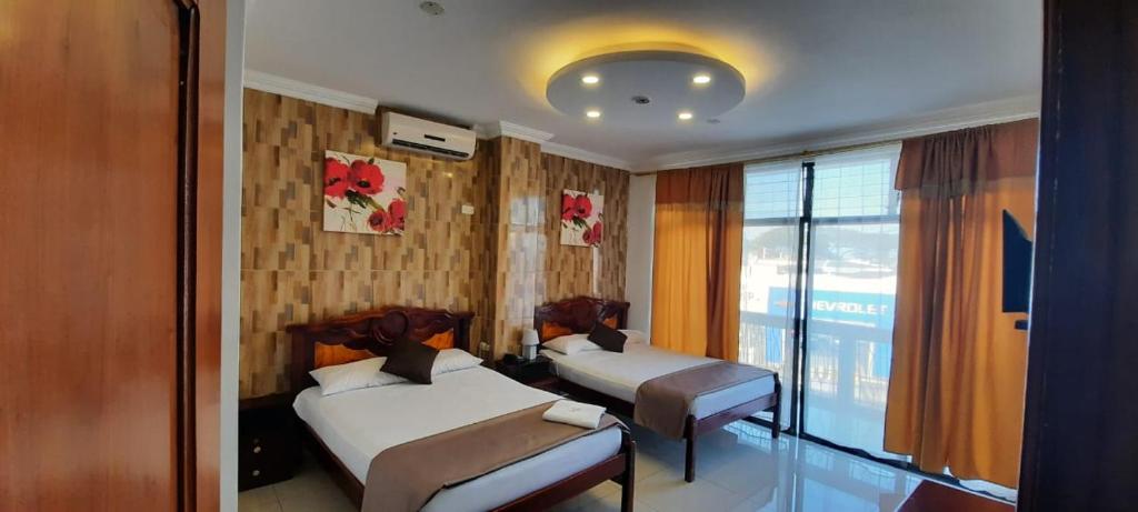 Postel nebo postele na pokoji v ubytování Hostal Perla Real Inn