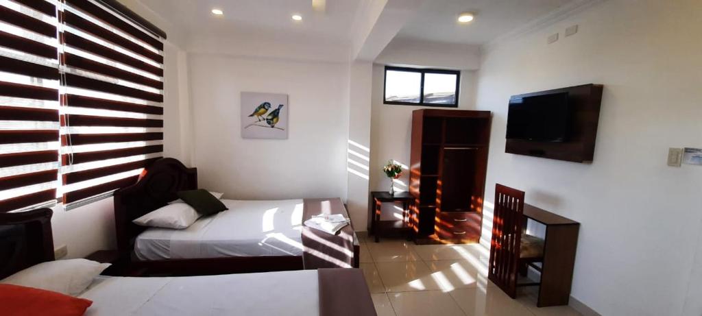 Postel nebo postele na pokoji v ubytování Hostal Perla Real Inn