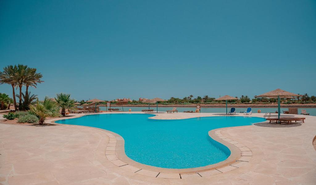 a large swimming pool in a resort at El Gouna 1 Bedroom Apartment west golf ground floor in Hurghada