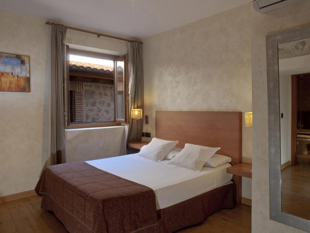 Postel nebo postele na pokoji v ubytování Hotel Las Leyendas