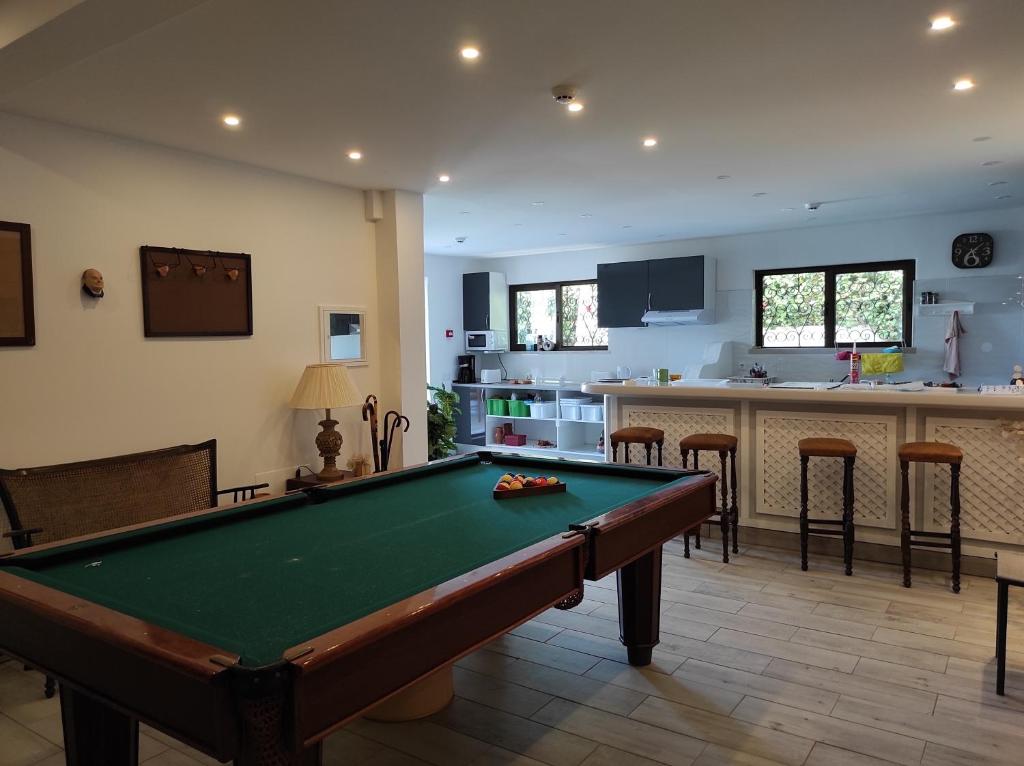 a living room with a pool table and a kitchen at Blife Sun Hostel in Faro