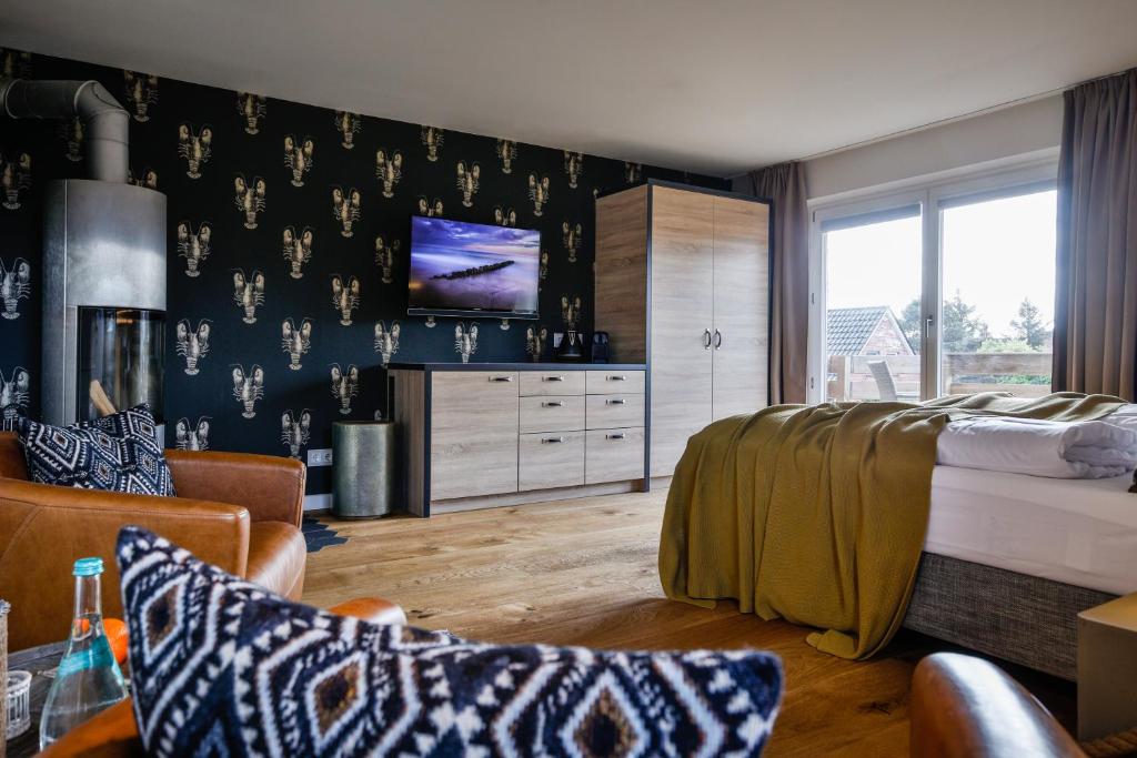 TV a/nebo společenská místnost v ubytování Landhaus Sylter Hahn