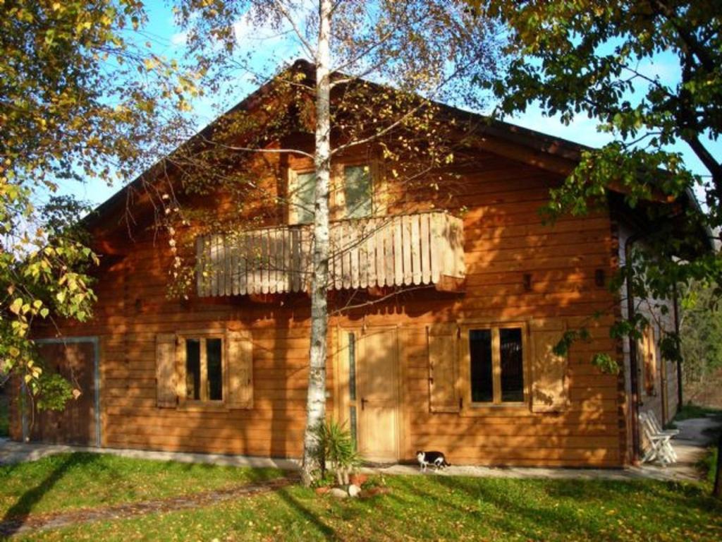 a log cabin with a balcony on the front of it at B&B Villa Letizia in Agrate Conturbia