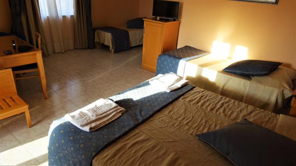 Postel nebo postele na pokoji v ubytování Hotel Bristol
