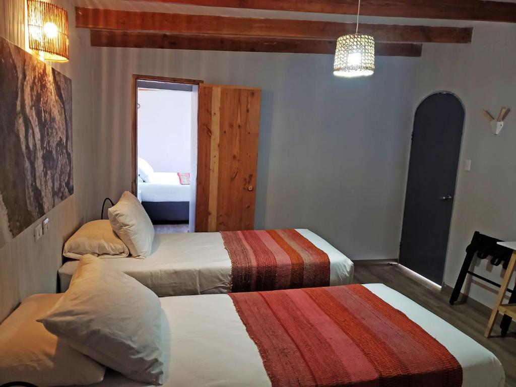 Postel nebo postele na pokoji v ubytování Hotel Jardin Atacama