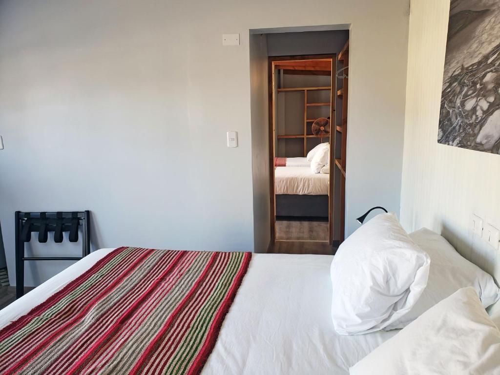 Postel nebo postele na pokoji v ubytování Hotel Jardin Atacama