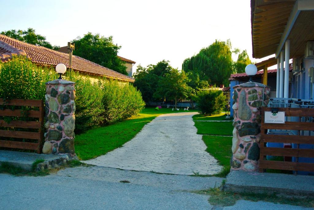 a driveway leading to a house with a gate at Kremasti Rooms in Kremastí