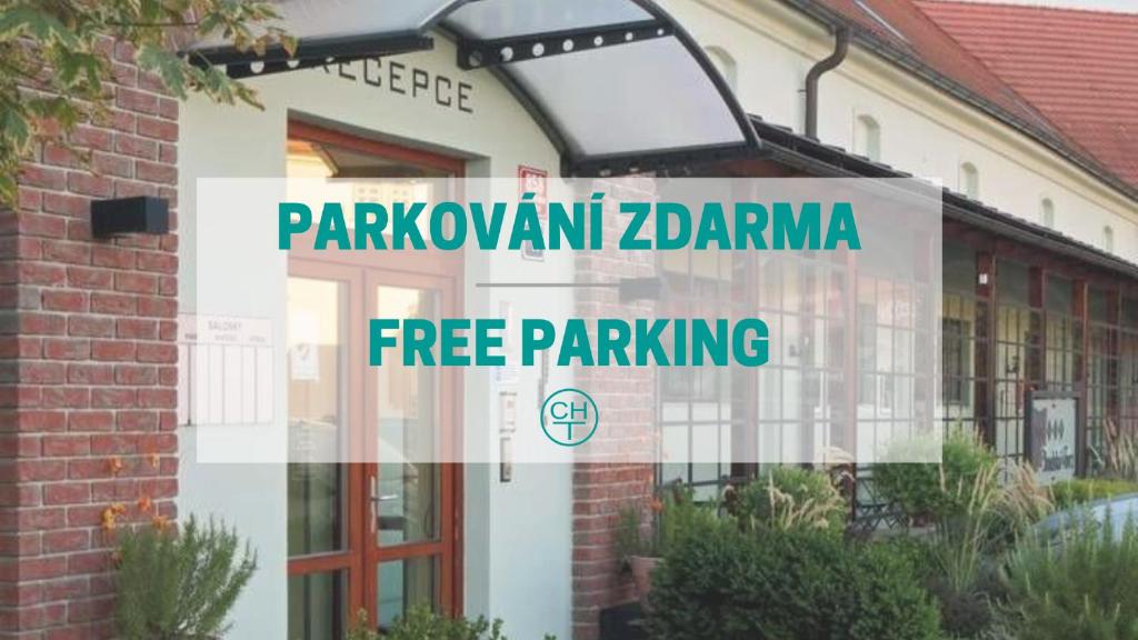 a building with a sign that reads parkowment zarmaarma free parking at Hotel Chvalská Tvrz in Prague