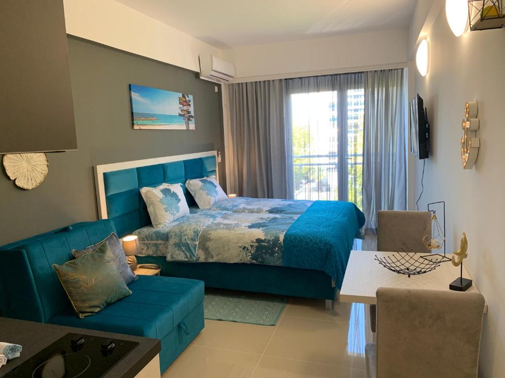 a bedroom with a blue bed and a couch at Sea&Center Lux in Bar