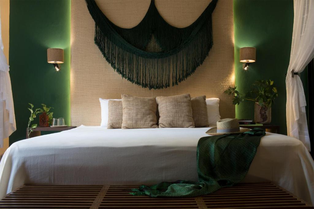 Postel nebo postele na pokoji v ubytování Ya'ax Hotel Boutique