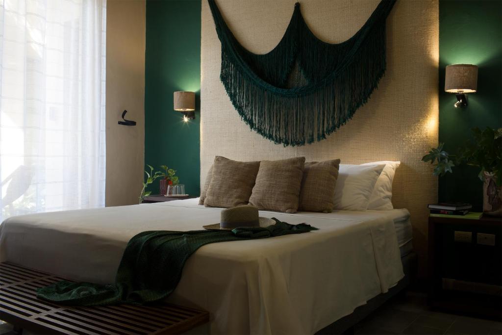 Postel nebo postele na pokoji v ubytování Ya'ax Hotel Boutique