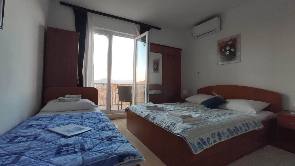Posteľ alebo postele v izbe v ubytovaní Guesthouse Podaca