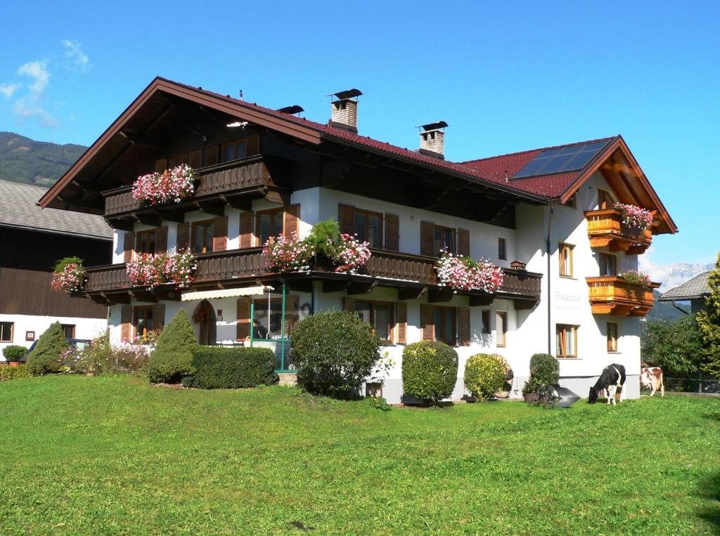 a large house with flowers on the front of it at Ehstandhof in Uderns