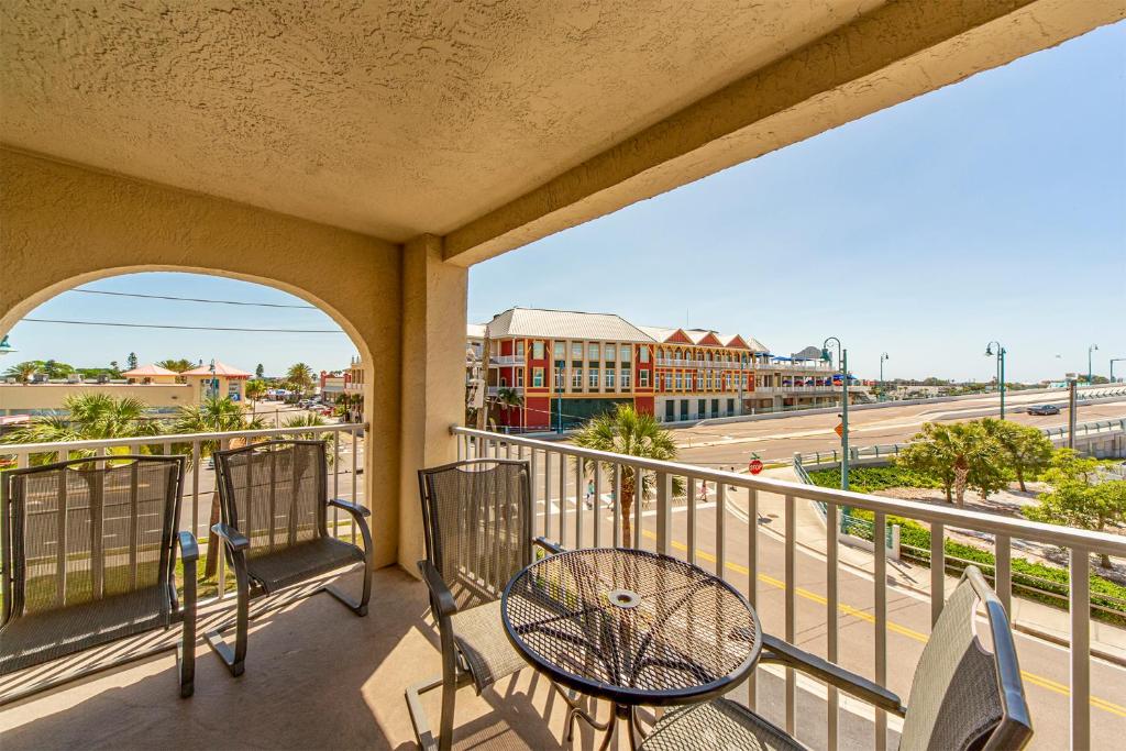 a balcony with chairs and a view of a street at 204 Beach Place Condos in St. Pete Beach