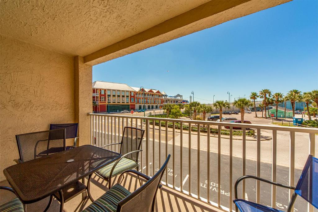 a balcony with a table and chairs and a view of the beach at 102 Beach Place Condos in St. Pete Beach