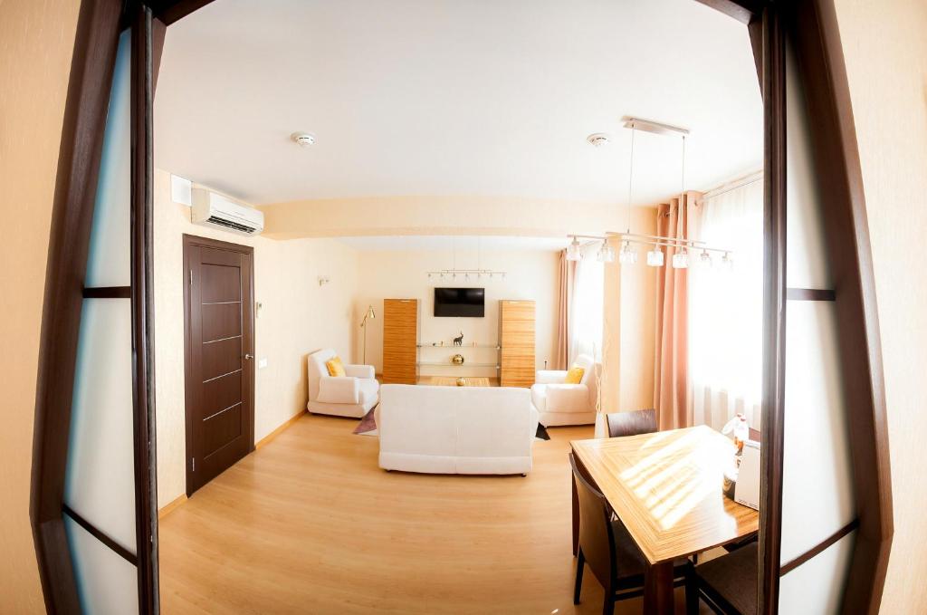 a large living room with a table and a living room at AZIMUT Hotel Siberia in Novosibirsk