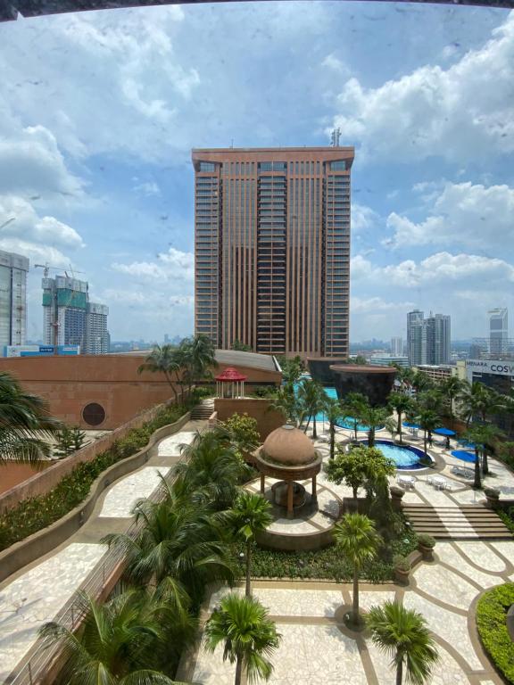 a view of a resort with a pool and a building at Jenet Service Suite At Times Square KL in Kuala Lumpur