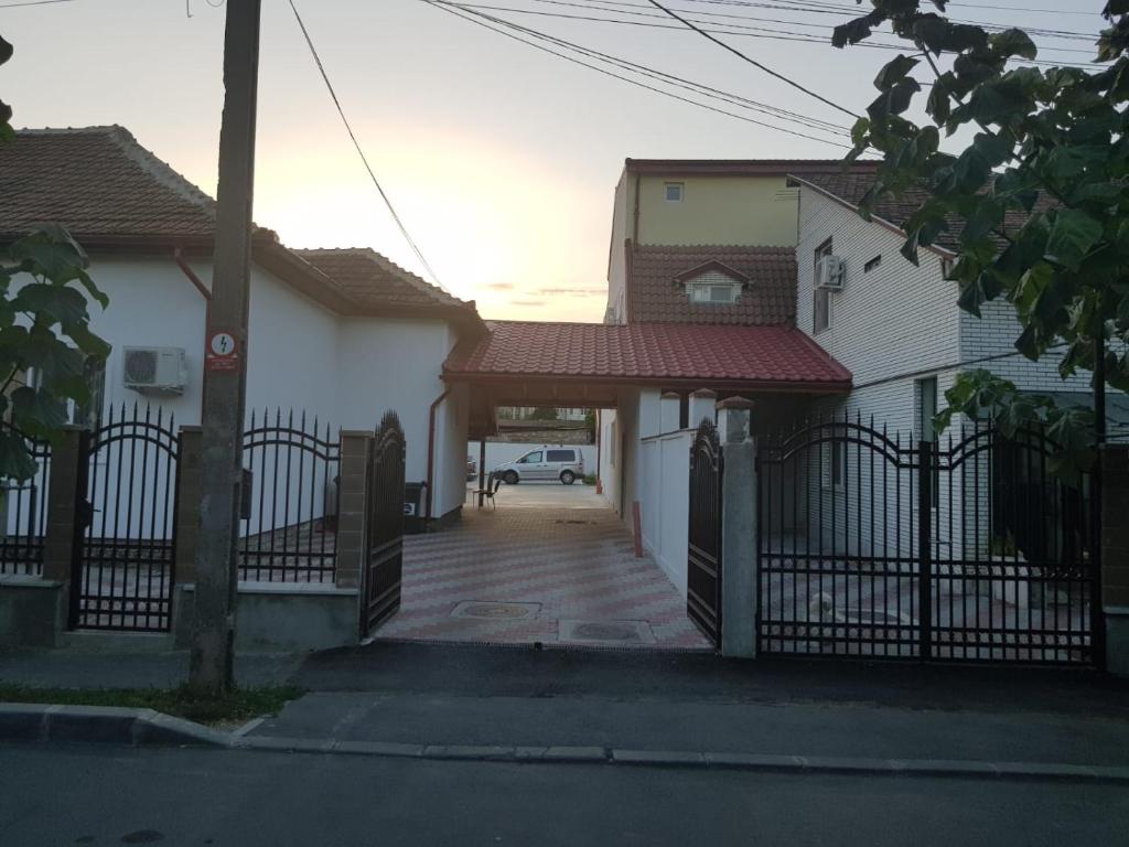 una valla frente a una casa con entrada en Georgiana Apartments, en Timisoara