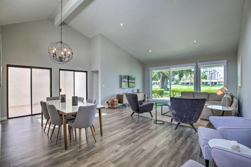 a dining room and living room with a table and chairs at Renovated Rancho Mirage Retreat with Resort Access! in Rancho Mirage