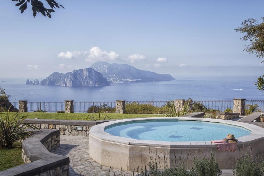 a swimming pool with a view of the ocean at VILLA CAMPANELLA - Sorrento Capri Positano - Exclusive Pool and garden in Massa Lubrense