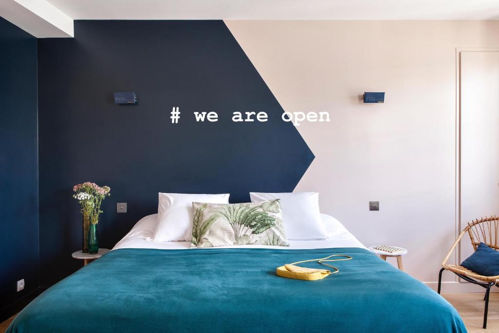 a bedroom with a blue bed with a banana on it at Hôtel Henriette in Paris