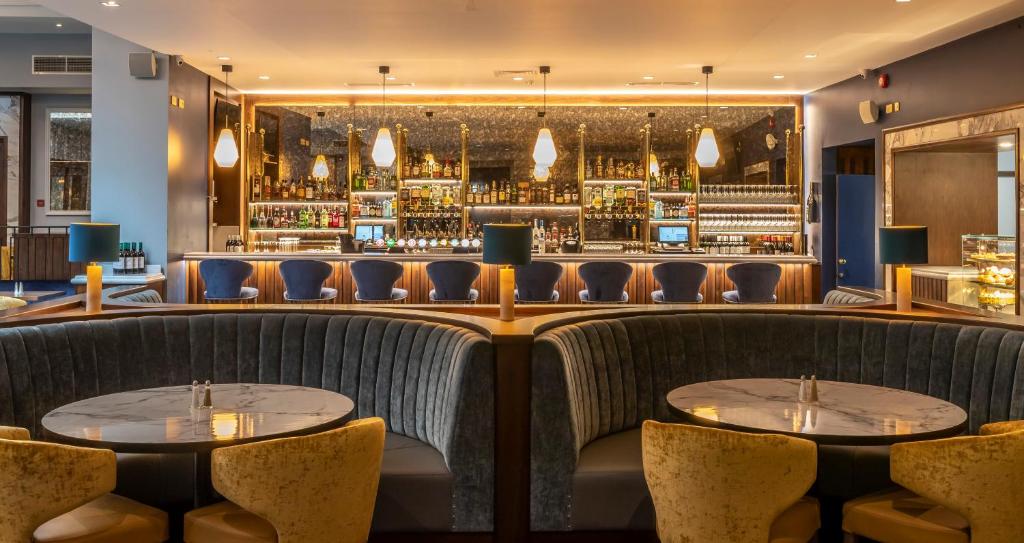 a bar with couches and tables in a restaurant at Grand Hotel in Malahide