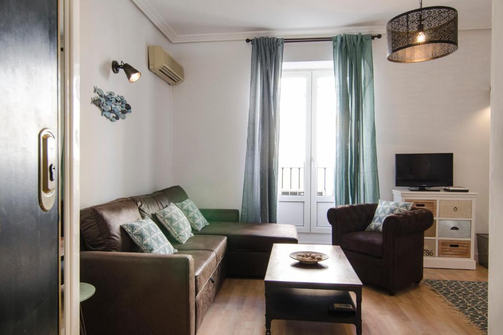 a living room with a couch and a tv at 1 bedroom 1 bathroom furnished - Chueca - bright in downtown area - MintyStay in Madrid