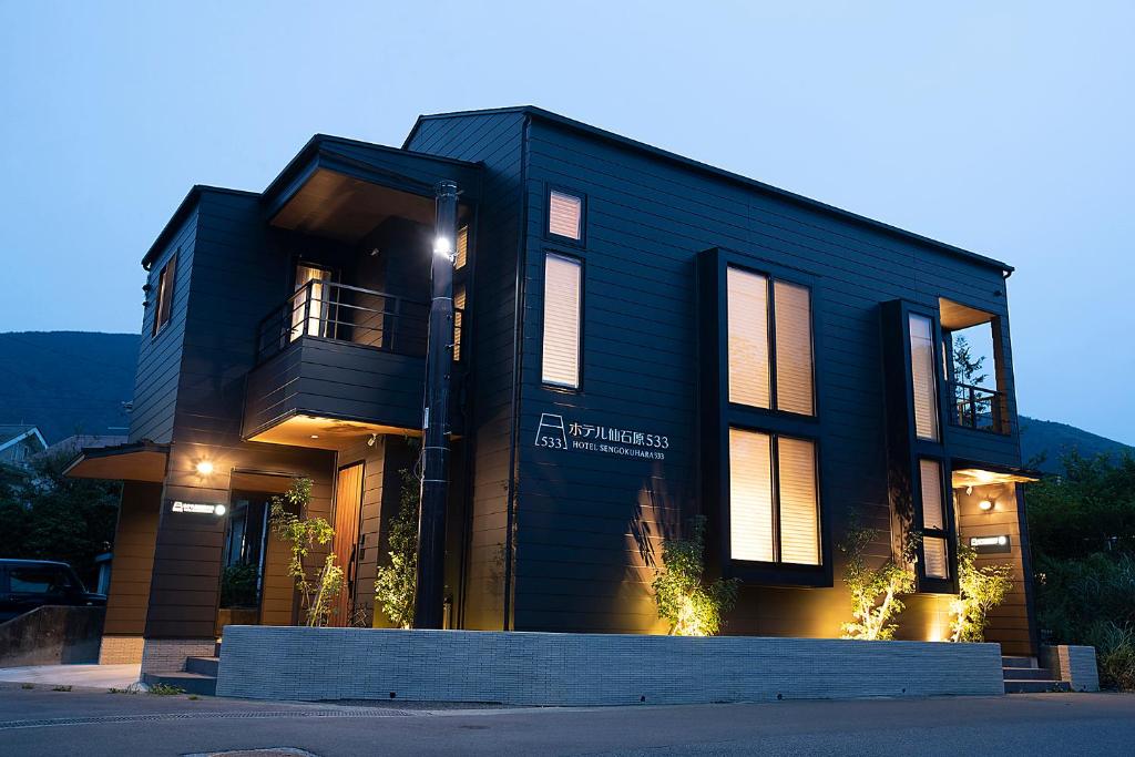 a black house with a sign on the front of it at Hotel Sengokuhara 533 in Hakone