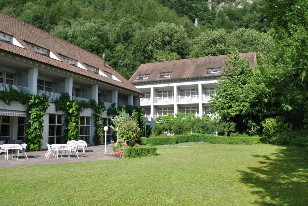 ein Gebäude mit Tischen und Stühlen im Hof in der Unterkunft Hotel Schlosswald in Triesen