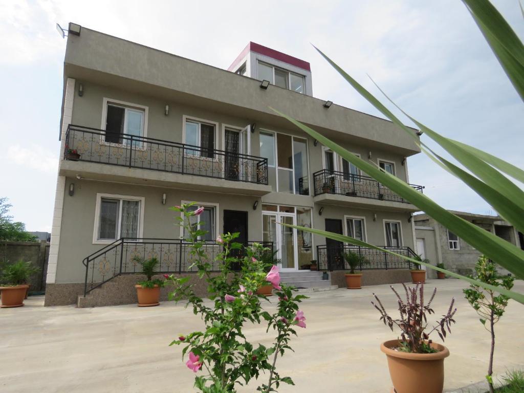 a building with plants in front of it at Apartments and cottages in Batumi in Batumi