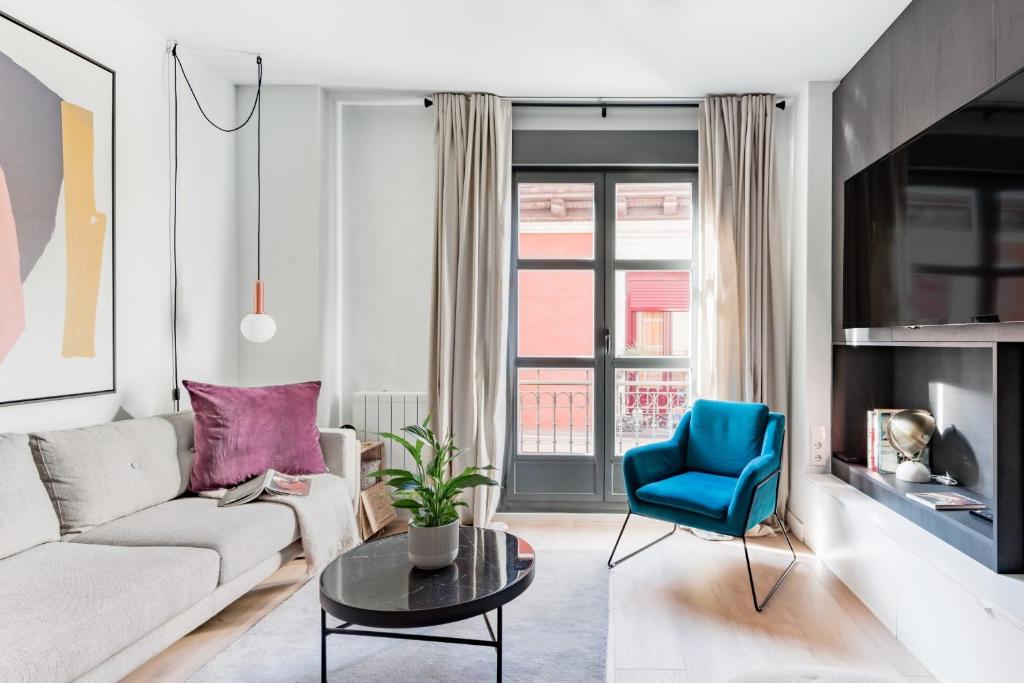 a living room with a white couch and a blue chair at Luxury and cozy- 2 bedrooms 2 bathrooms -MintyStay- Herradores in Madrid