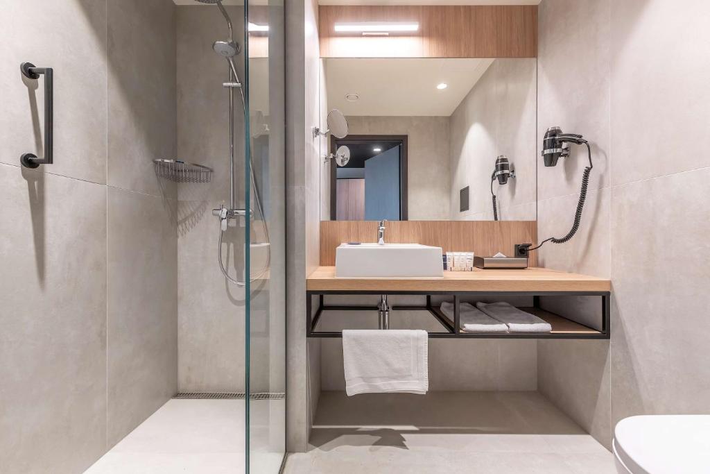 a bathroom with a sink and a shower at Park Inn by Radisson Vilnius Airport Hotel & Conference Centre in Vilnius