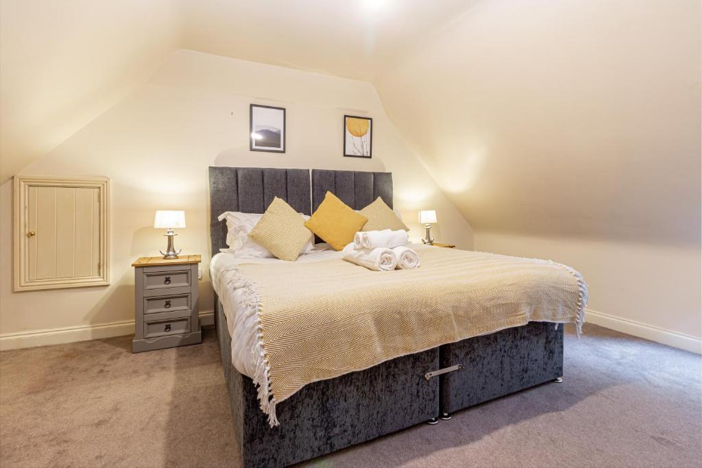 a bedroom with a large bed in a attic at Guest Homes - Hillbrook House Dwelling in Great Malvern