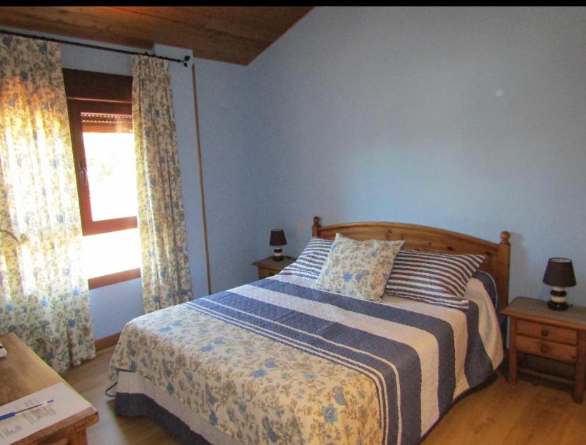 1 dormitorio con cama y ventana en Casa Rural San Isidro, en Valdepiélagos