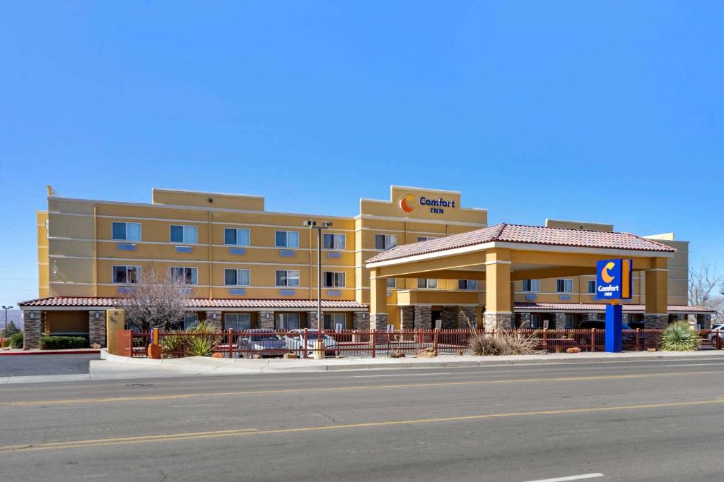 a hotel on the side of a road with a street at Comfort Inn Albuquerque Airport in Albuquerque