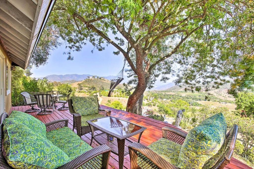 a porch with chairs and a table with a view at Hilltop Home in Wine Country with Hot Tub and Views! in Fallbrook