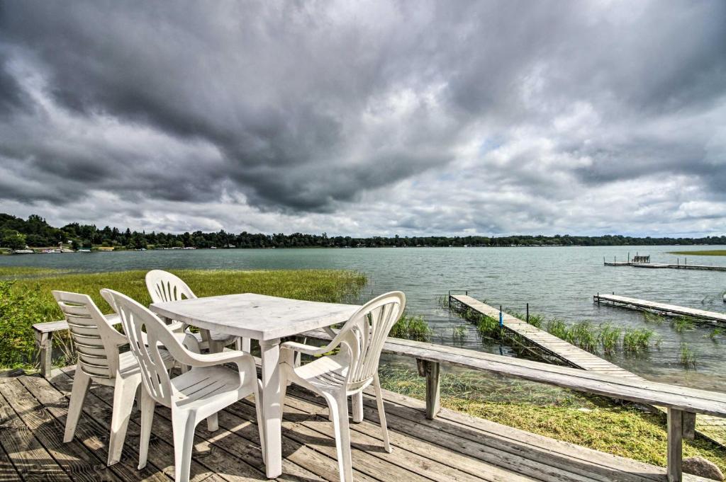 a table and chairs sitting on a dock next to the water at Lake Retreat Fire Pit, Boat Rentals, BBQ! in Dent