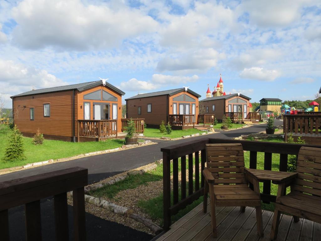 uma fila de casas com um banco no convés em Gulliver's Valley, M1, JCT 31 em Rotherham